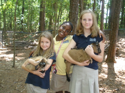 Adolescent Program students care for goats as part of their practical life experiences.