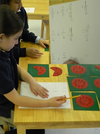Primary student working with the Fraction Metal Insets.